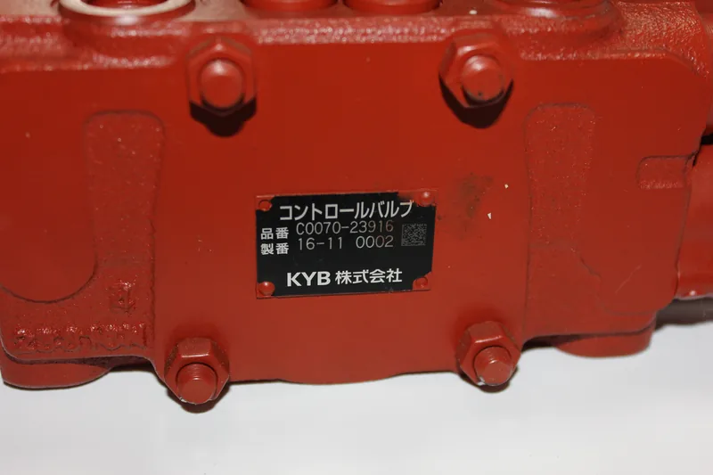 Control valve identification plate mounted on a red valve body