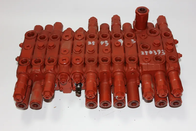 Red multi-section control valve showing ports and mounting interfaces
