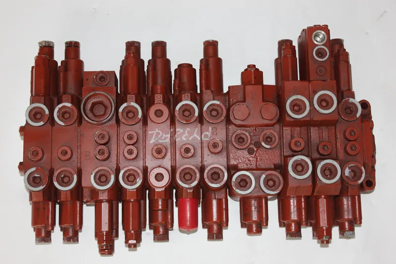 Front view of a red multi-section hydraulic control valve